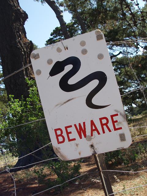 a beware of snakes warning sign