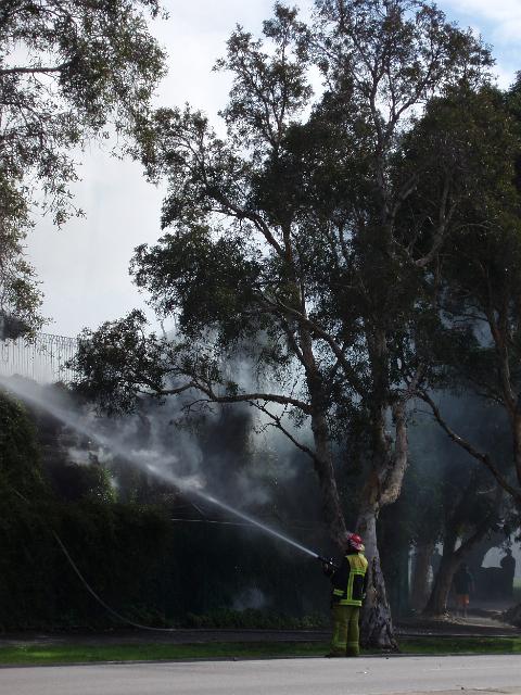 an australian fire fighter aka fire-o extinguishing a fire