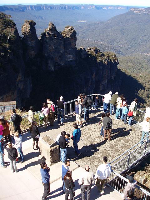 tourists in the blue mountains enjoying the view from echo point, katoomba