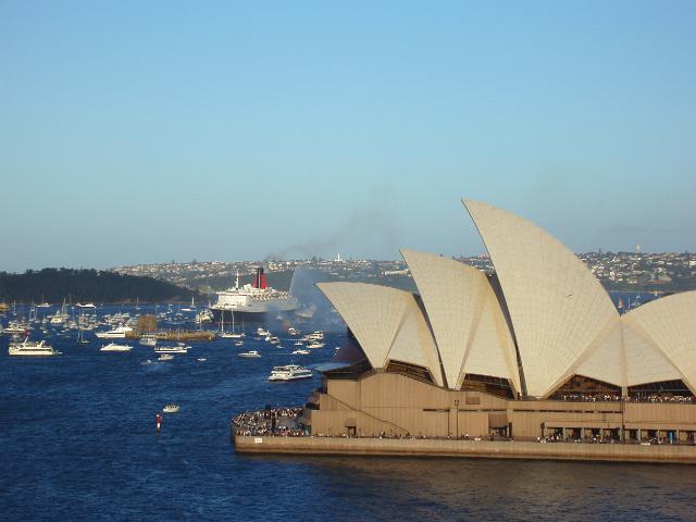 iconic sydney landmark and symbol of australia with the QEII arriving in sydney harbour to the rear