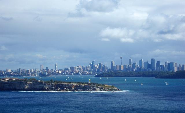 a wide angle image taking in the sydney city skyline, the famous harbour and the hornby lighthouse on south head