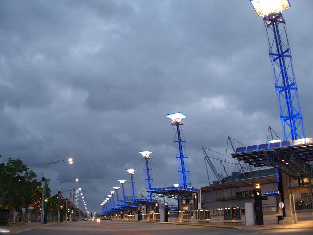 a view of sydney olympic park at dusk, streets lined with solar powered lighting