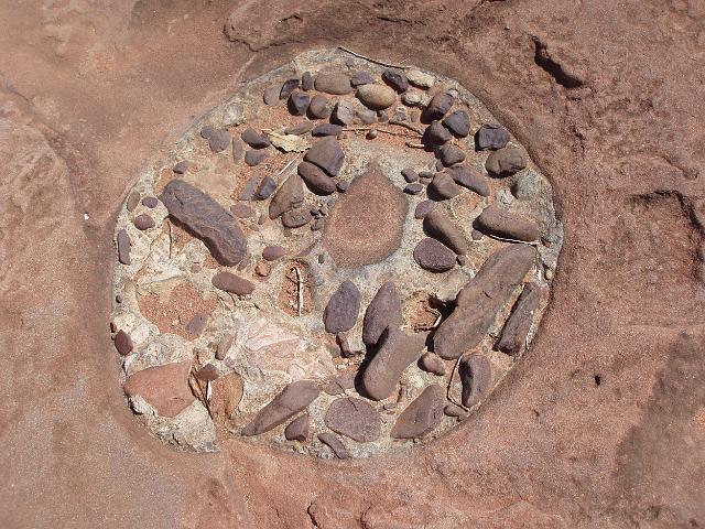 an unusual rock formation caused by water eroding an composite rock structure