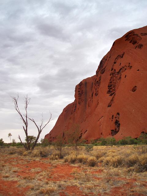 a view from the walk around the base of uluru on a cloudy day