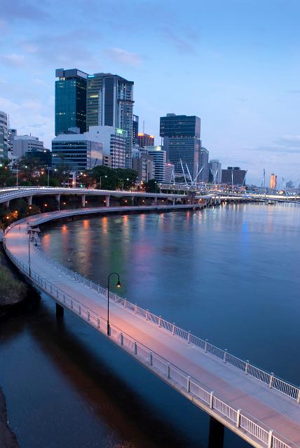 a twilight view of the brisbane riverside cycle and walking track with office blocks of central brisbane in the background