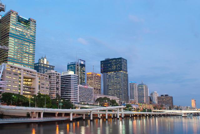 Central Brisbane at twilight with the lights from the highrise buildings reflected in the calm water of the Brusbane River below