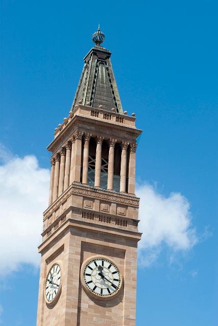 Brisbane City Hall Clock Tower, a historical landmark in the city centre showing two of the clock faces and the colonnade against a clear blue sky