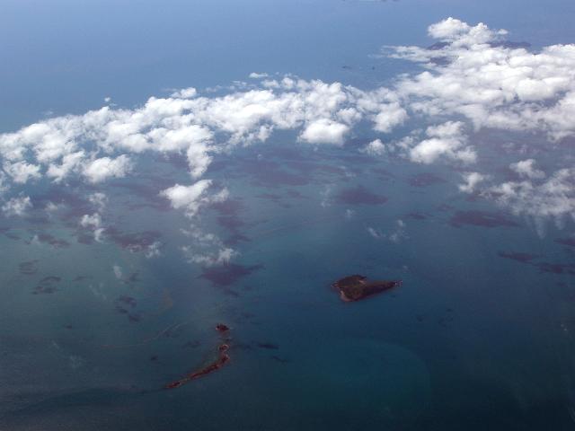 an aerial view of several coral islands in the queensland whitsunday island group