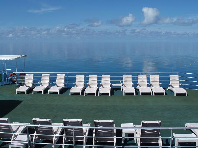 sun loungers on a sundeck looking out over the coral sea, queensland