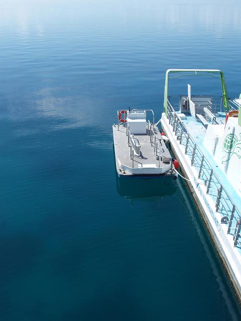 boats moored on still water near at knuckle reef pontoon