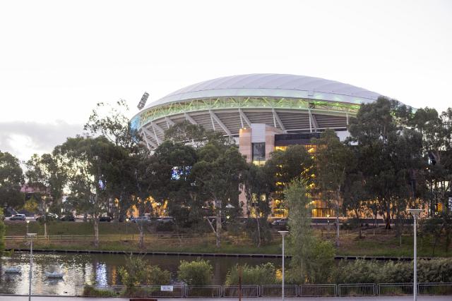 View of the Adelaide Oval Cricket Ground over leafy green shrubs in the Adelaide, Australia parklands providing an international sports venue