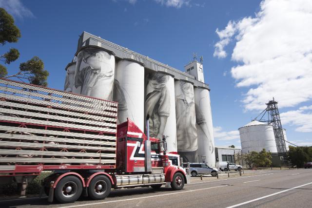 Large semi truck passing the grain silos at Coonalpyn as it drives along the Dukes Highway in South Australia