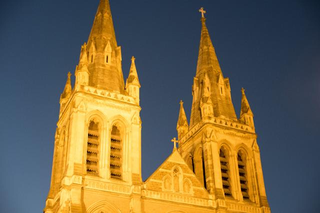 Illuminated twin spires of St Peters Cathedral in Adelaide, Australia at twilight in a close up low angle exterior view