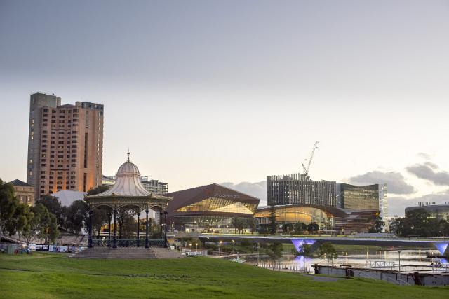 The purpose built Adelaide Convention Centre, North Terrace, Adelaide, Australia exterior at dusk with a green lawn and pavilion in the foreground