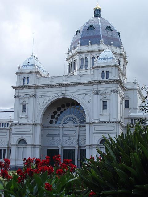 side view of the royal exhibition building, with the flowerbeds of carlton gardens in the foreground