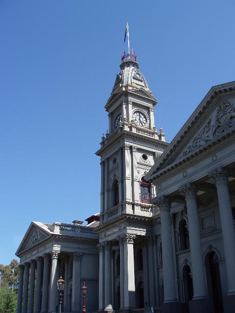 grand town hall building at fitzroy, melbourne pictured against a clear blue sky