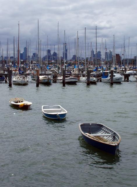 boats moored in the marnina at st kilda, skyline of melbournes office towers can be seen in the rear