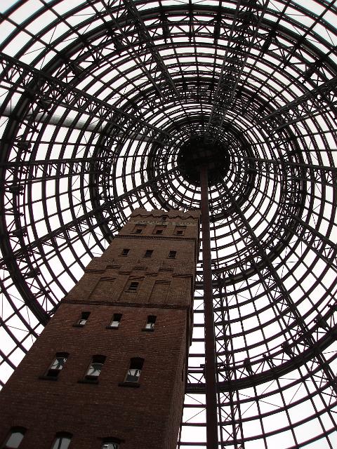 tall brick shot tower is a landmark now enclosed in the conical dome of melbourne central shopping centre