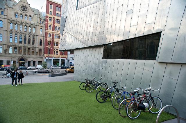 Bicycles parked outside a modern building in Federation Square in Melbourne, Australia, a civic centre in the CBD area of the city