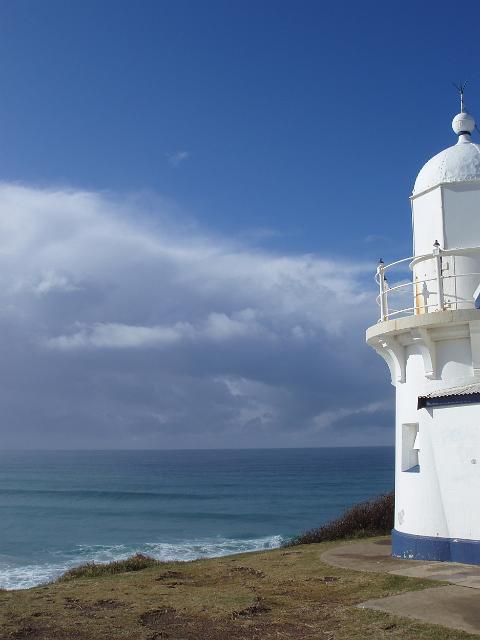 a white and blue painted light house near port macquarie overlooking lighthouse beach