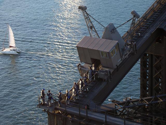 people standing on top of sydneys habour harbour bridge
