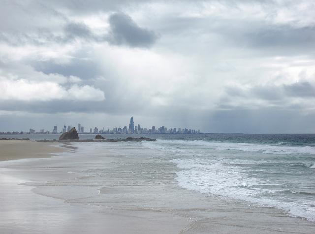 currumbin beach on a cloudy day with the high rise buildings of surfers paradise in the background, gold coast, QLD