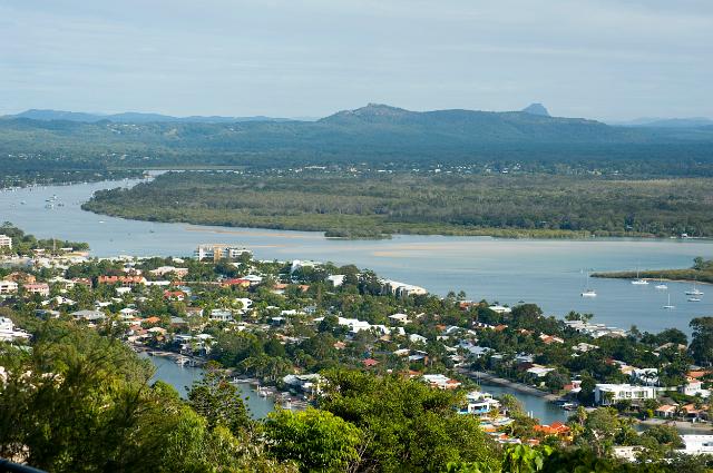 Scenic landscape view of Noosa, Queensland, Australia showing the town at the mouth of the river and lush green countryside leading to a distant mountain range