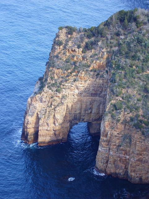 a natural rock arch on the tasman peninsula between cape pillar and cape hauy